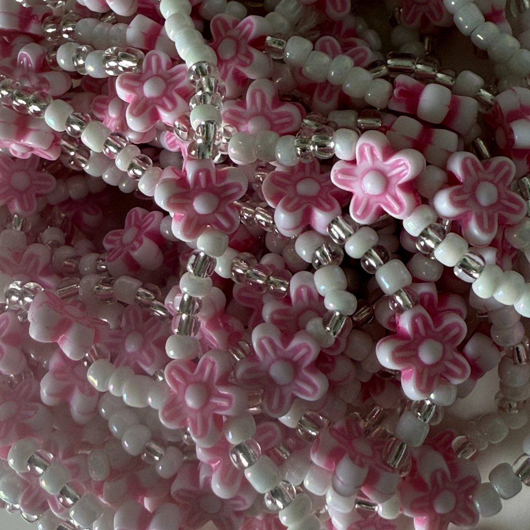 pink and white waist beads with floral designs. waist beads for weight loss