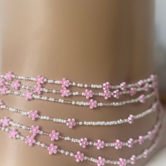pink and white waist beads with floral designs. waist beads for weight loss